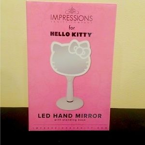 Hello Kitty hand mirror with standing base.